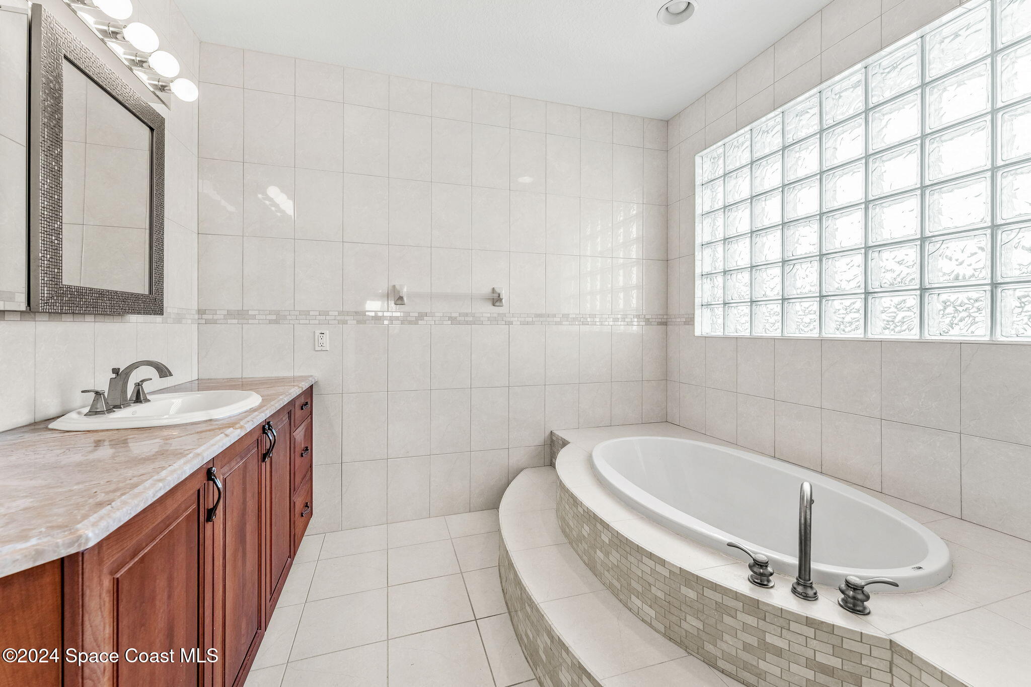 1600 Elm Drive West Melbourne, FL 32935 - Photo 19 of 79 a bathroom with a granite countertop sink a toilet a mirror and bathtub
