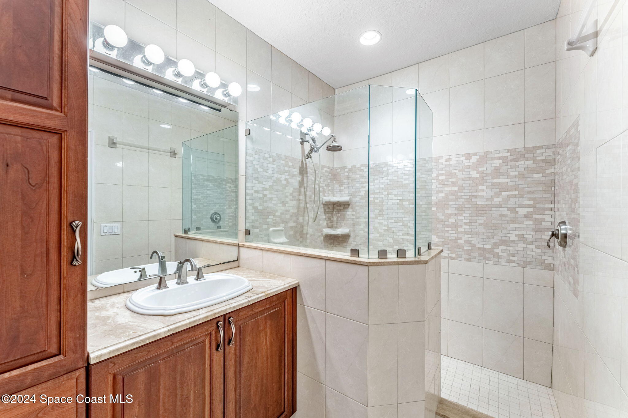 1600 Elm Drive West Melbourne, FL 32935 - Photo 21 of 79 a bathroom with a double vanity sink mirror and shower