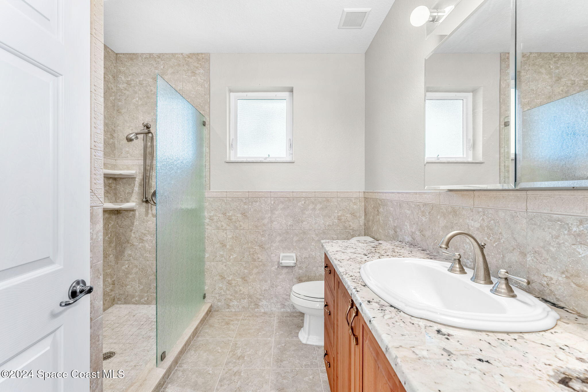 1600 Elm Drive West Melbourne, FL 32935 - Photo 29 of 79 a bathroom with a granite countertop sink toilet and shower