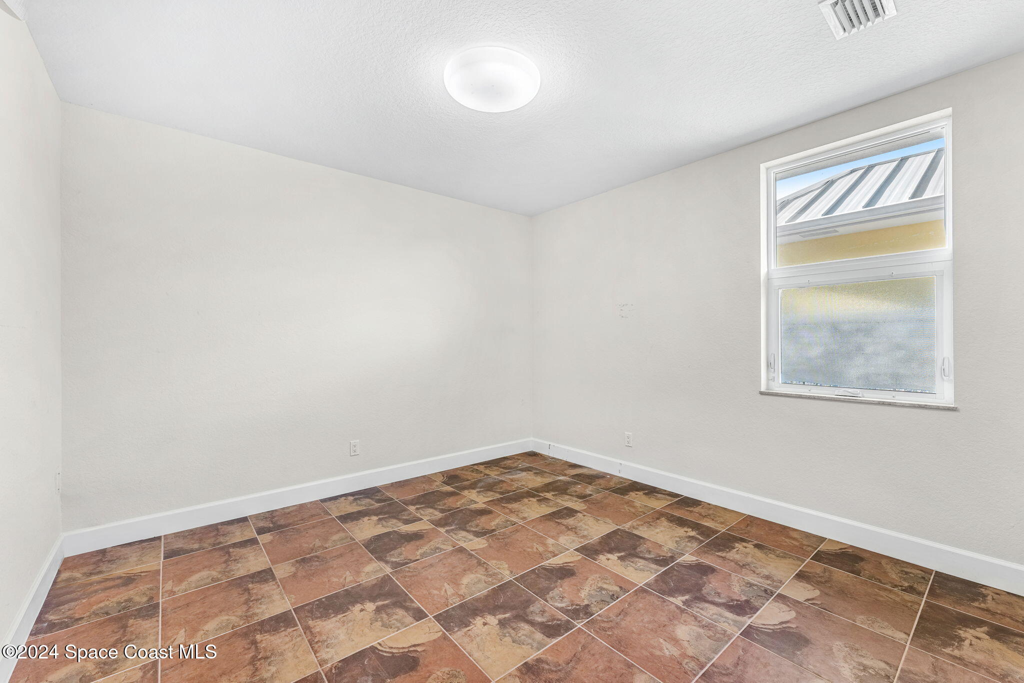 1600 Elm Drive West Melbourne, FL 32935 - Photo 33 of 79 an empty room with a window