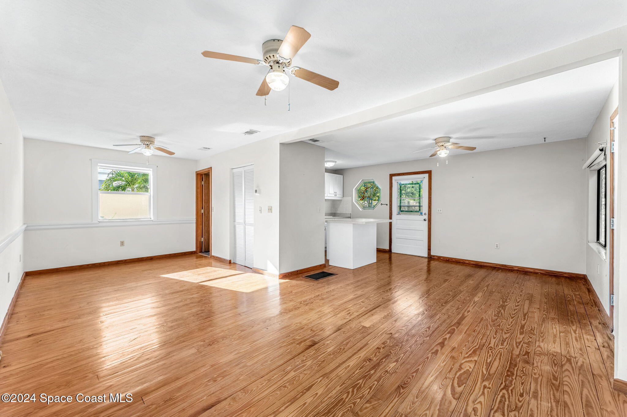 1600 Elm Drive West Melbourne, FL 32935 - Photo 53 of 79 a view of an empty room with window and wooden floor