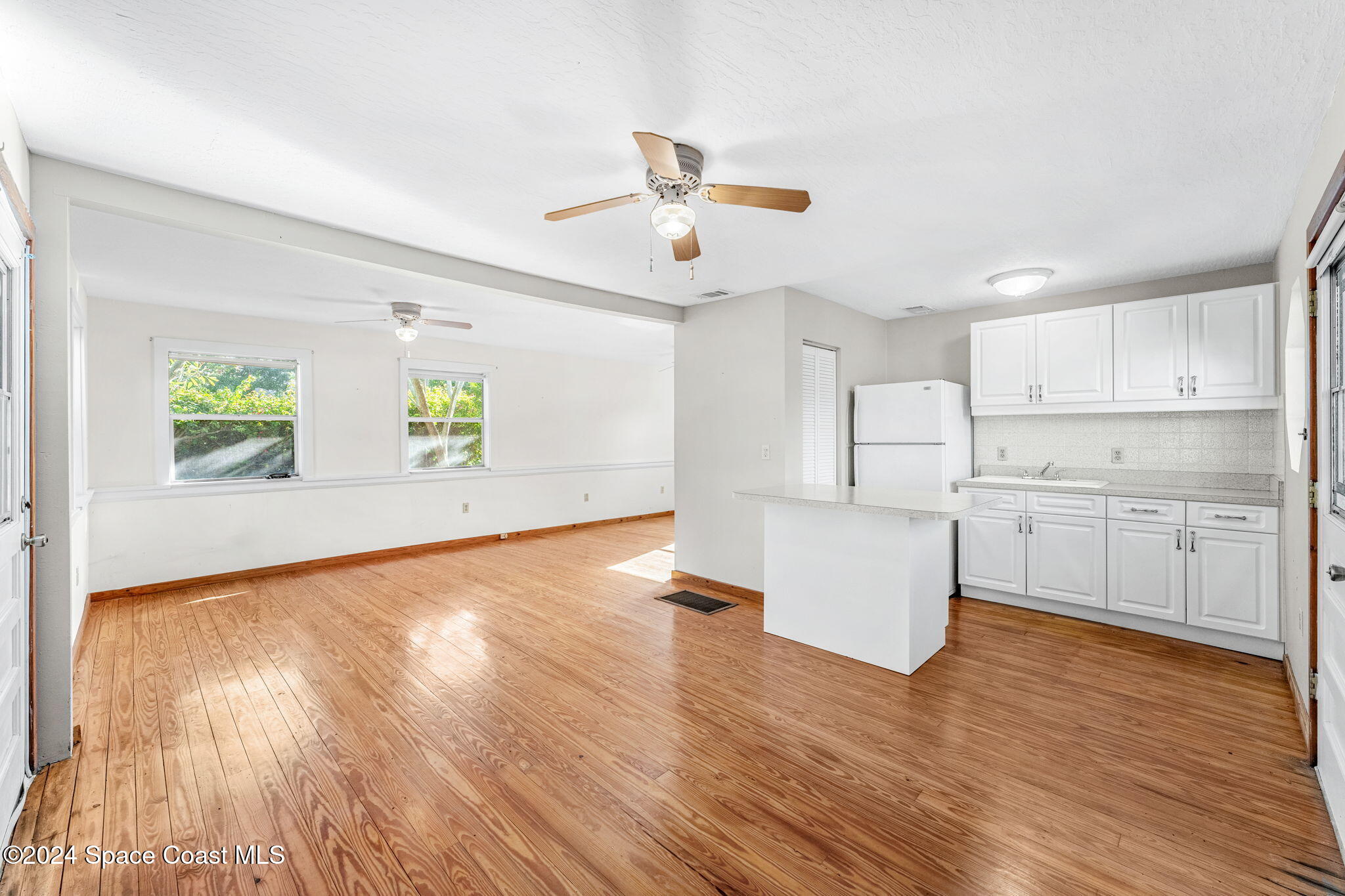 1600 Elm Drive West Melbourne, FL 32935 - Photo 55 of 79 a living room with stainless steel appliances kitchen island hardwood floor and a window