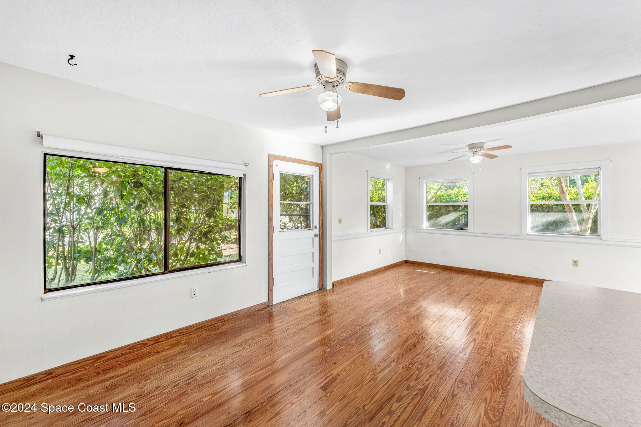 1600 Elm Drive West Melbourne, FL 32935 - Photo 57 of 79 a view of an empty room with a window and wooden floor