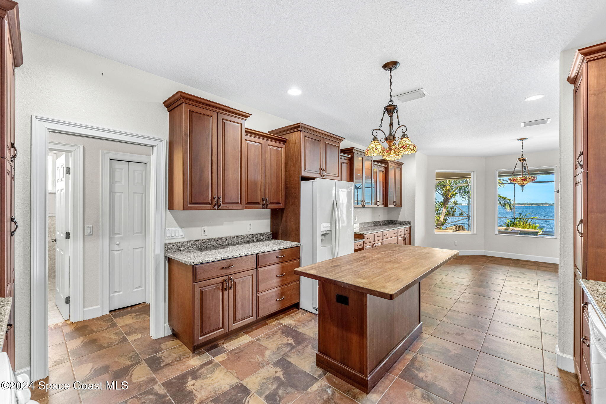 1600 Elm Drive West Melbourne, FL 32935 - Photo 9 of 79 a view of kitchen with stainless steel appliances granite countertop a stove top oven a sink dishwasher and a refrigerator with wooden floor