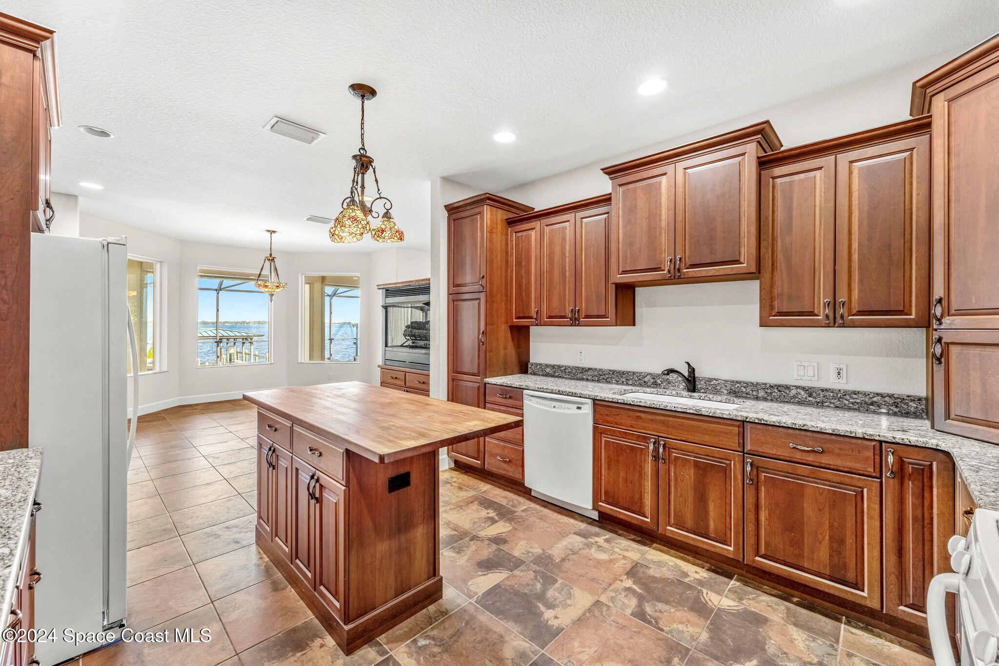 1600 Elm Drive West Melbourne, FL 32935 - Photo 10 of 79 a kitchen that has a lot of cabinets in it and stainless steel appliances
