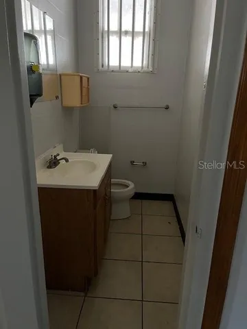 a bathroom with a sink toilet and window
