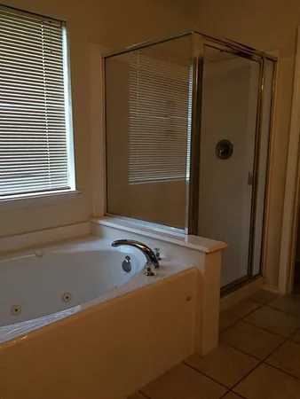 a bath tub sitting next to a shower