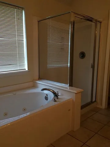 a bath tub sitting next to a shower