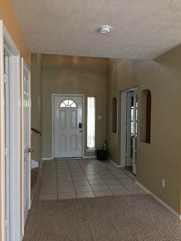 2527 Liza Court Spring, TX 77388 - Photo 23 of 23 a view of a hallway with wooden floor and a bathroom