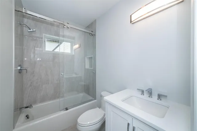 a bathroom with a sink mirror toilet and bathtub