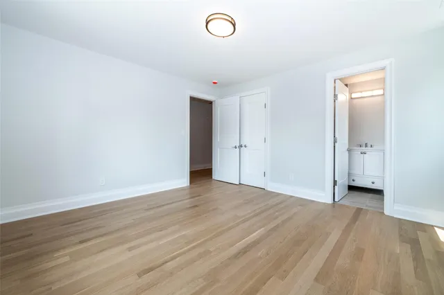 a view of an empty room and wooden floor