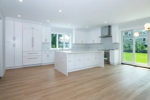 a view of a kitchen with wooden floor and windows
