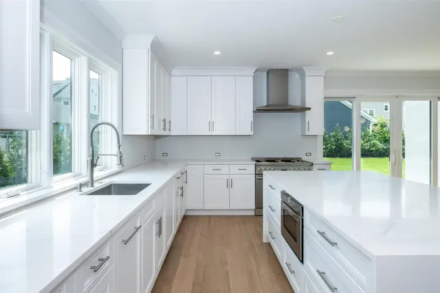 a kitchen with granite countertop white cabinets and white appliances