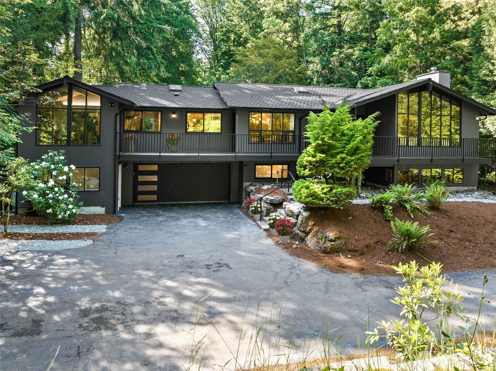 6423 East Mercer Way Mercer Island, WA 98040 - Photo 2 of 39 a front view of a house with a yard