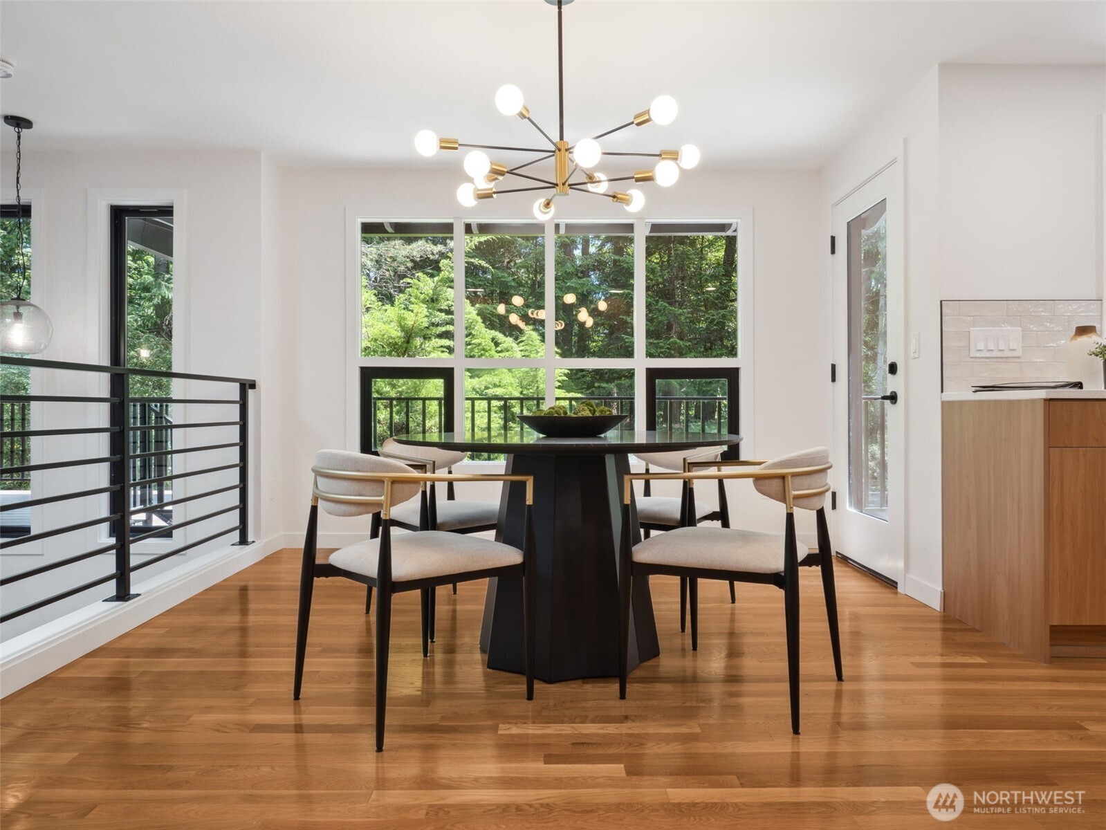 6423 East Mercer Way Mercer Island, WA 98040 - Photo 4 of 39 a dining room with wooden floor a chandelier a glass table and chairs
