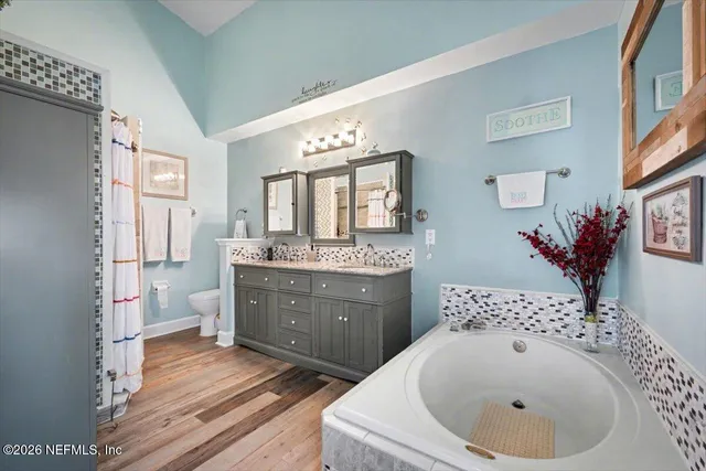 a spacious bathroom with a sink a toilet and a mirror