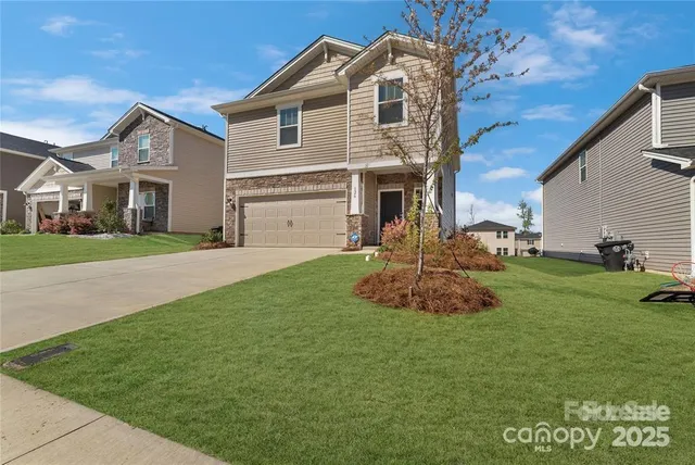 a front view of a house with a garden