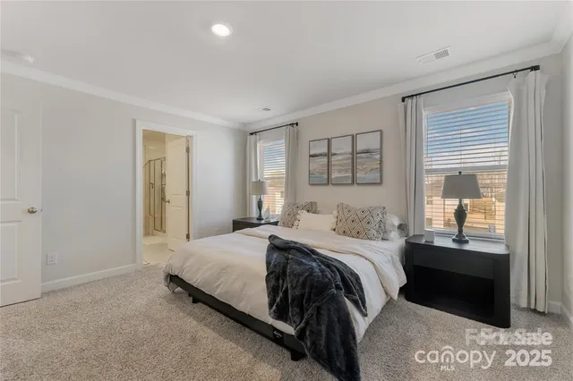 a bedroom with a bed and a view of bathroom