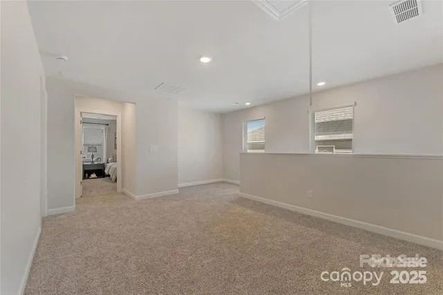 an empty room with windows and closet