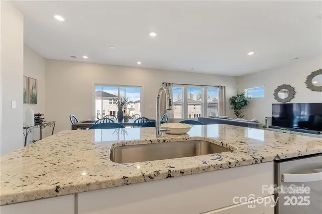 a kitchen with granite countertop a sink and a counter top space