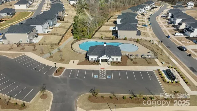 an aerial view of a house with a swimming pool