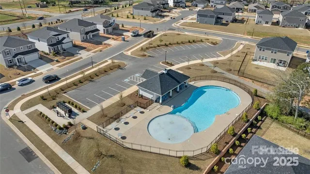 an aerial view of a house with swimming pool