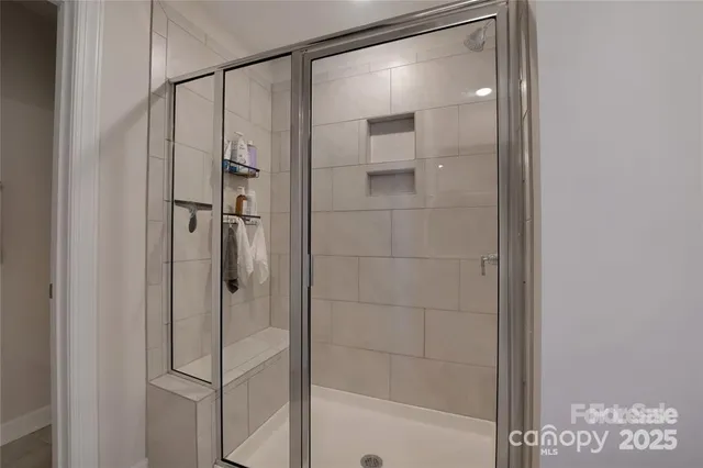a bathroom with a glass shower door