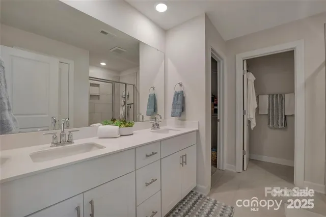 a bathroom with double sink and a mirror