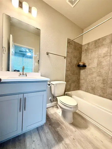 a bathroom with a sink a toilet and a bathtub