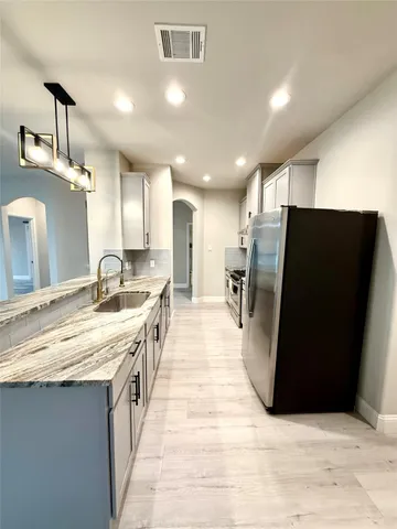 a view of a livingroom with a furniture wooden floor and a kitchen