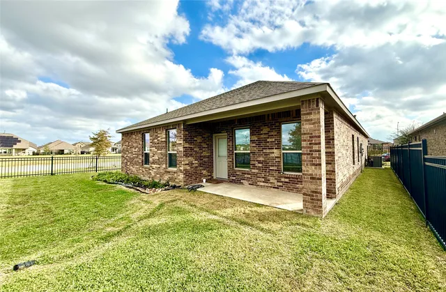 a view of a house with backyard porch and sitting area