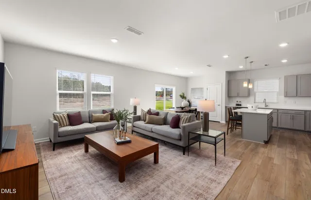 a kitchen with a sink a refrigerator a stove and white cabinets