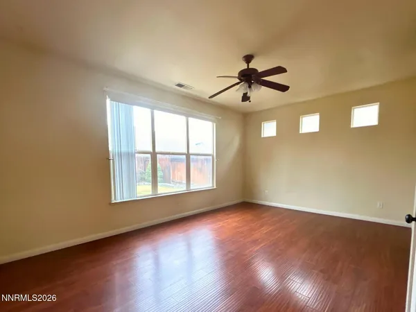 a view of a livingroom with a ceiling fan and window
