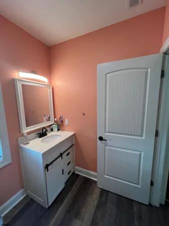 a bathroom with a sink toilet and mirror