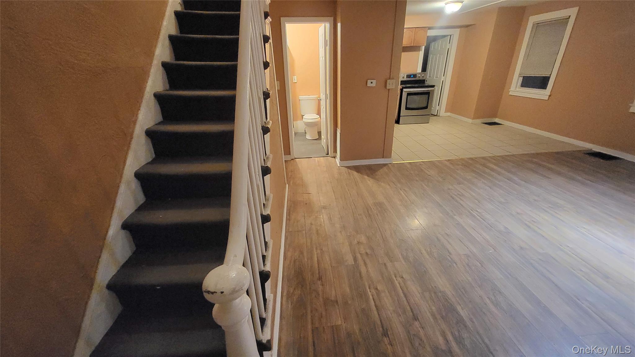 92 Academy Street Poughkeepsie, NY 12601 - Photo 13 of 28 an entryway of a house with wooden floor and windows