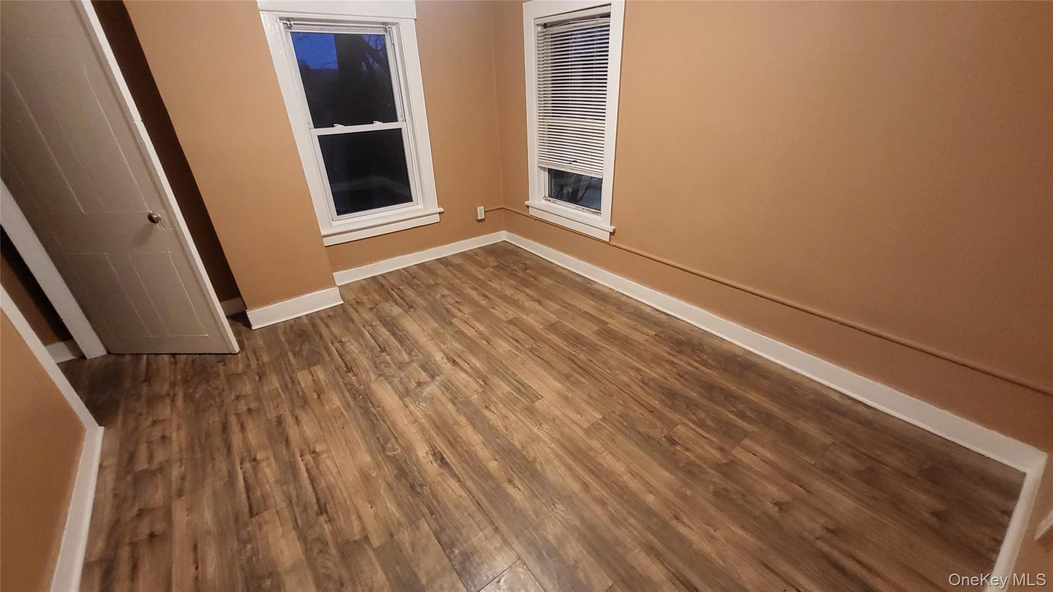 92 Academy Street Poughkeepsie, NY 12601 - Photo 21 of 28 a view of an empty room with wooden floor and a window
