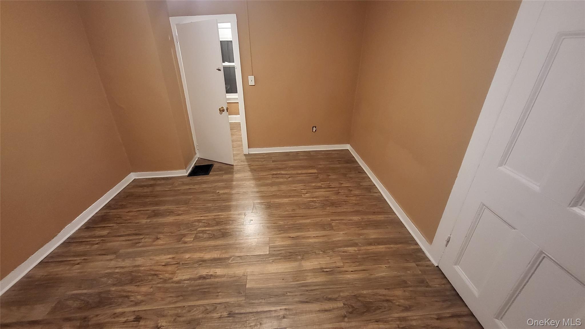 92 Academy Street Poughkeepsie, NY 12601 - Photo 23 of 28 a view of an empty room with wooden floor