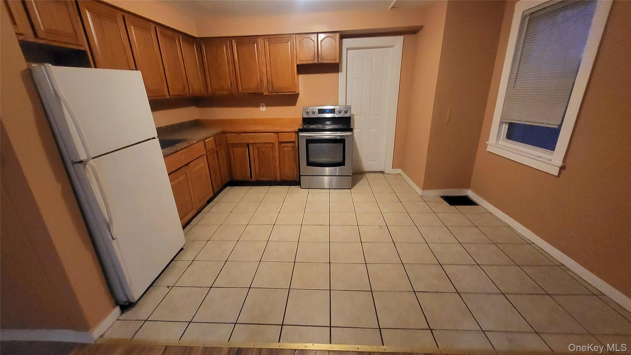 92 Academy Street Poughkeepsie, NY 12601 - Photo 4 of 28 a kitchen with granite countertop a refrigerator and a stove top oven