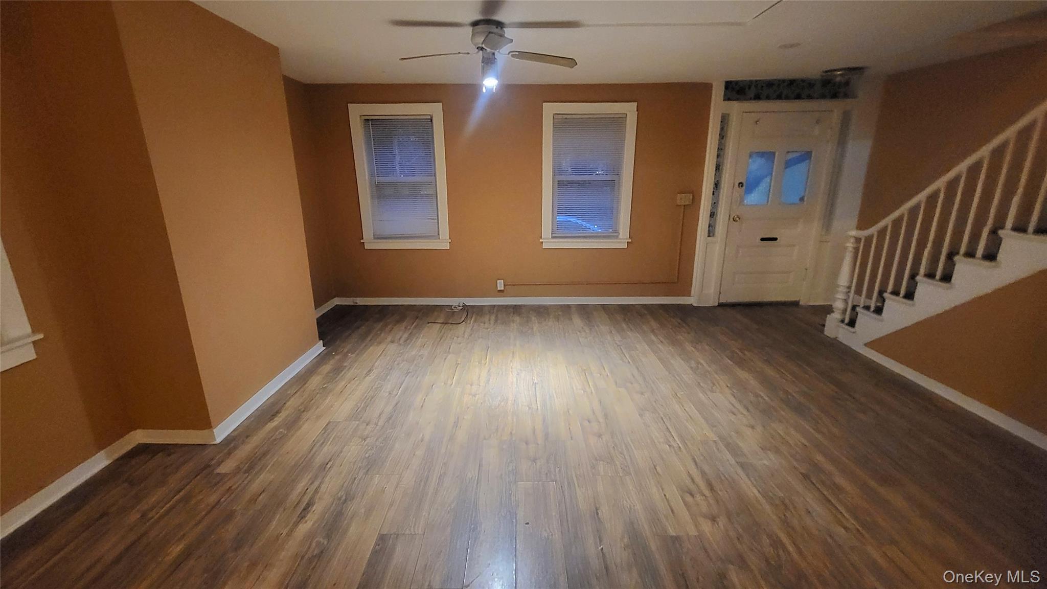 92 Academy Street Poughkeepsie, NY 12601 - Photo 8 of 28 a view of an empty room with wooden floor and a window