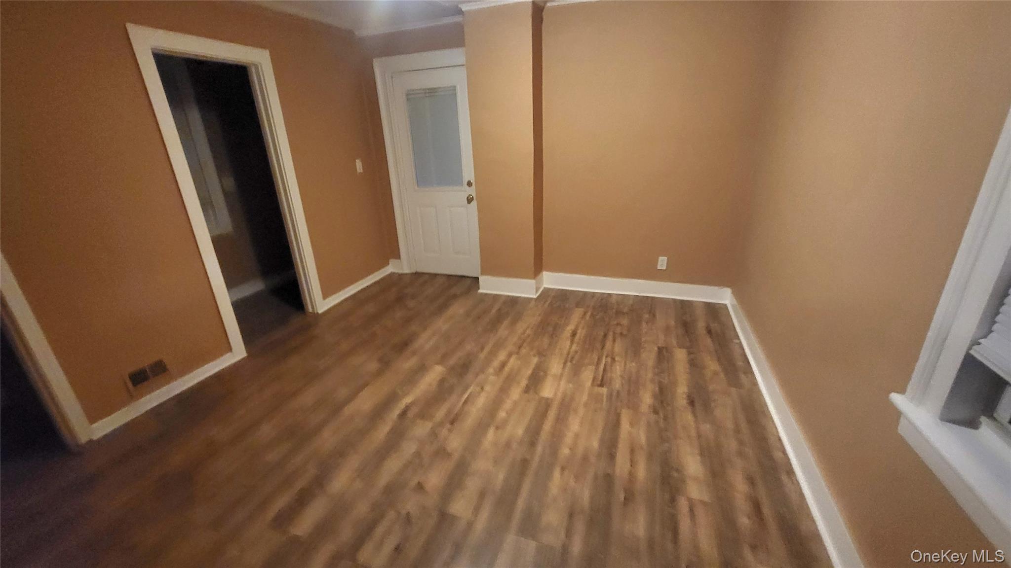 92 Academy Street Poughkeepsie, NY 12601 - Photo 10 of 28 an empty room with wooden floor and closet