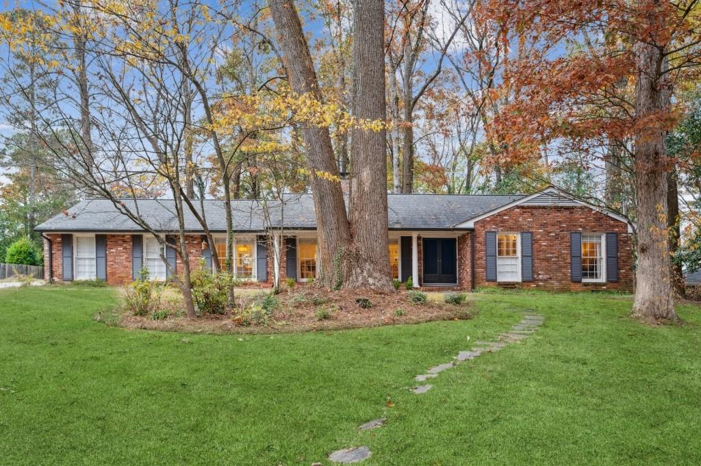 a front view of house with yard and green space