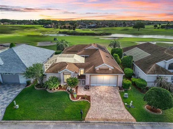 an aerial view of a house with big yard