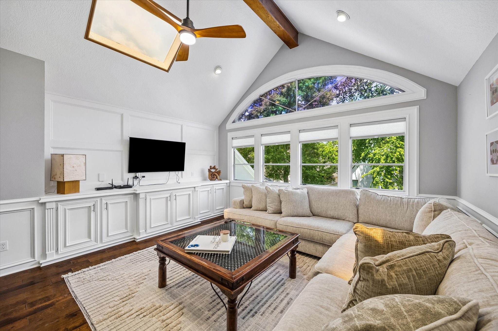 146 Golden Shadow Circle Spring, TX 77381 - Photo 26 of 41 This upstairs living area showcases soaring vaulted ceilings with exposed wood beam detailing and custom millwork cabinetry. A dramatic wall of windows topped with an arched transom fills the space with natural light.