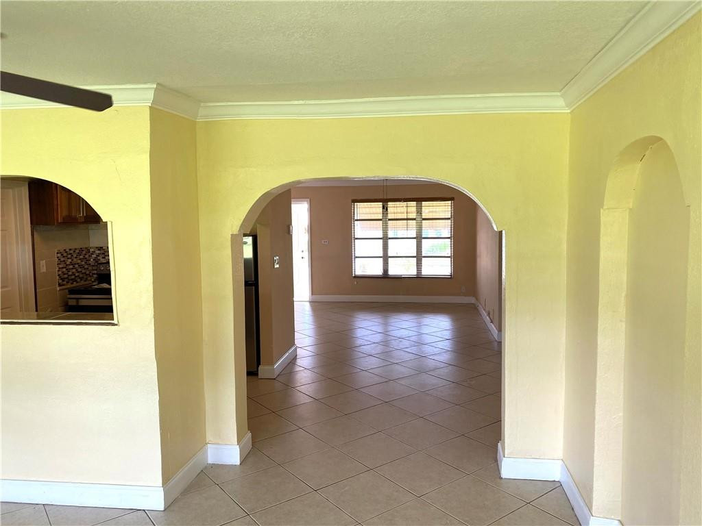 5019 Northwest 49th Road Tamarac, FL 33319 - Photo 11 of 25 a view of a hallway with wooden floor and a living room