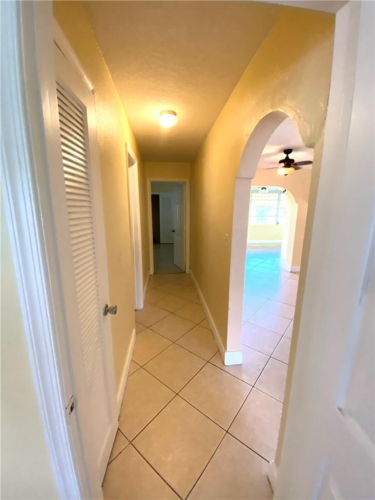 5019 Northwest 49th Road Tamarac, FL 33319 - Photo 20 of 25 a view of a hallway with wooden floor and glass door