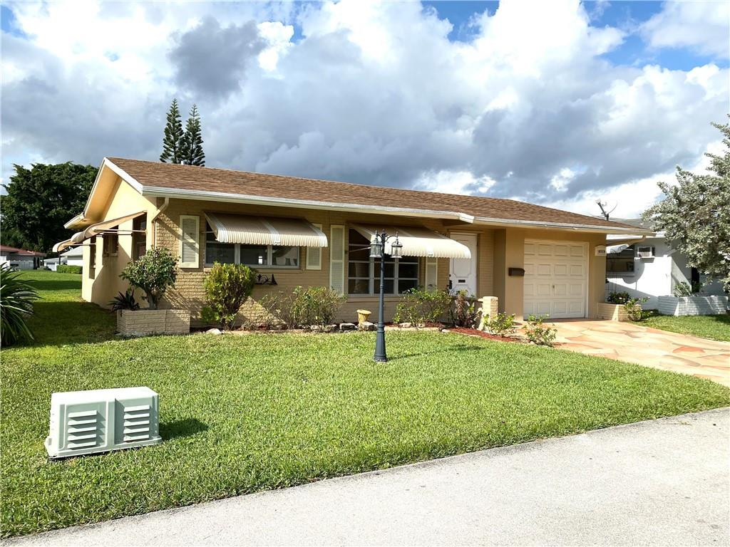5019 Northwest 49th Road Tamarac, FL 33319 - Photo 2 of 25 a view of a house with a yard