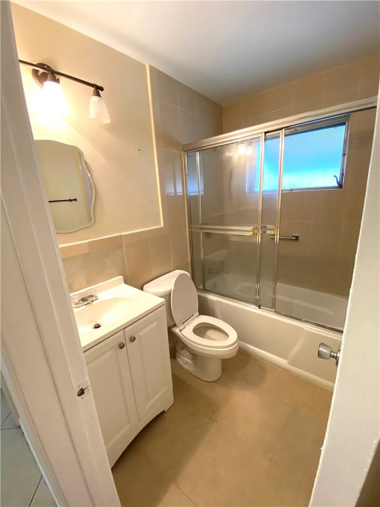 5019 Northwest 49th Road Tamarac, FL 33319 - Photo 21 of 25 a bathroom with a granite countertop sink toilet and shower