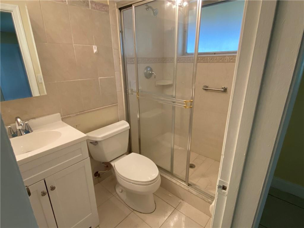 5019 Northwest 49th Road Tamarac, FL 33319 - Photo 23 of 25 a white toilet sitting next to a bathroom sink