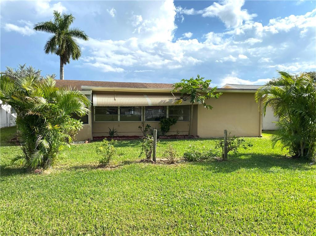 5019 Northwest 49th Road Tamarac, FL 33319 - Photo 7 of 25 front view of house with a yard