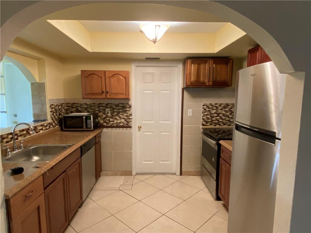 5019 Northwest 49th Road Tamarac, FL 33319 - Photo 10 of 25 a kitchen with a refrigerator and a sink